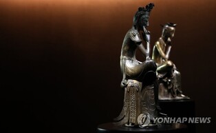 Gilt-bronze Buddhist statues on display