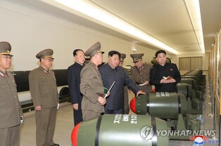 (LEAD) N. Korean leader urges more production of weapons-grade nuclear materials; photos of tactical nuclear warheads released
