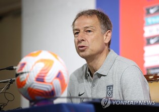 Klinsmann trying to show support for midfielder held in China
