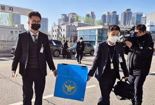 Police raid ex-defense chief's office