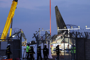 Crane removing wreckage from plane crash