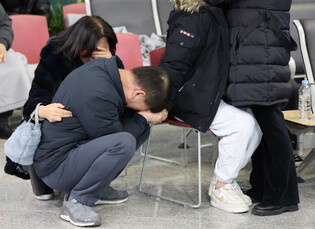 Families of plane crash victims mourn