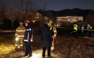 Police, firefighters inspect self-immolation site