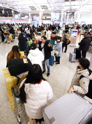 Airport bustles with outbound holiday tourists