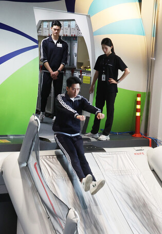 Flight attendants conduct emergency exit drill