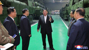 N.K. leader inspects factory producing multiple rocket launchers