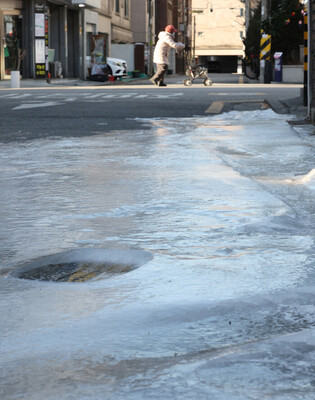 Frozen road due to ruptured water pipe