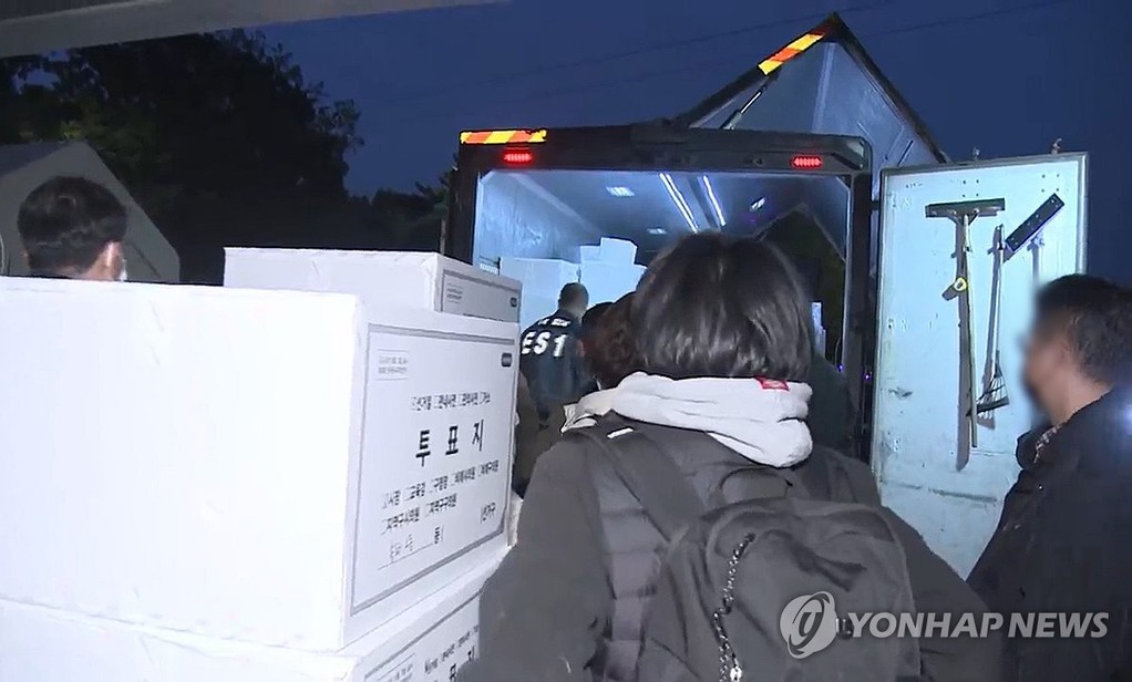 This image provided by Yonhap News TV shows ballot boxes being transported from the Olympic Park Handball Gymnasium in southeastern Seoul on Oct. 29, 2026, following an inspection by a special counsel team. (PHOTO NOT FOR SALE) (Yonhap)