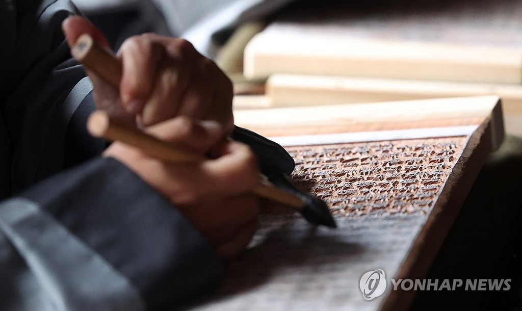 해인사, 팔만대장경 판각 시연 (합천=연합뉴스) 김동민 기자 = 해인사 스님 등이 29일 오후 경남 합천군 법보종찰 해인사 탑마당에서 국보이자 세계기록유산인 팔만대장경(8만1천352장)을 새롭게 판각하는 '해인사 장경도감 대장경 판각 고불식(告佛式)'에서 전통 판각을 시연하고 있다.
약 800년 전 대장경 조성 정신과 원력(願力·염원)을 현시대로 잇기 위해 대장경 전체를 한 본 더 제작하는 이번 불사는 완료까지 50∼100년가량 소요될 예정이다. 2026.10.29 image@yna.co.kr