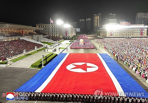 North Korean people holding the flag of their country march at Kim Il Sung Square in Pyongyang on Sept. 8, 2026, the eve of the 78th anniversary of the North's national founding, in this photo released by the North's official Korean Central News Agency the next day. (For Use Only in the Republic of Korea. No Redistribution) (Yonhap)