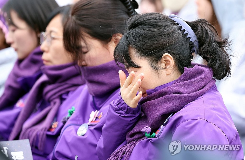 A bereaved family member wipes tears during a memorial event marking the fourth anniversary of the Itaewon crowd crush at Seoul's Gwanghwamun Square on Oct. 29, 2026. (Pool photo) (Yonhap)