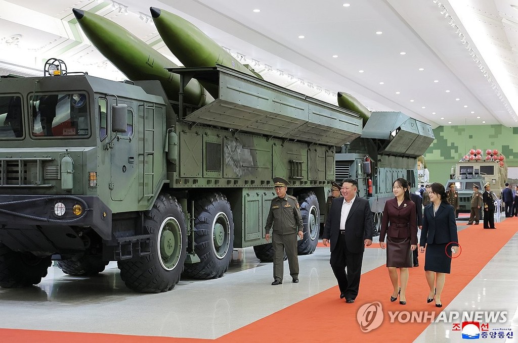 North Korean leader Kim Jong-un (C), accompanied by his wife, Ri Sol-ju (R), and daughter Ju-ae (2nd from R), walks past a vehicle carrying missiles as he inspects the National Defense Revolution Museum in Pyongyang on Oct. 11, 2026, in this photo released by the North's official Korean Central News Agency on Oct. 13. Ri is holding what appear to be a cigarette pack and a matchbox in her hand. (For Use Only in the Republic of Korea. No Redistribution) (Yonhap)